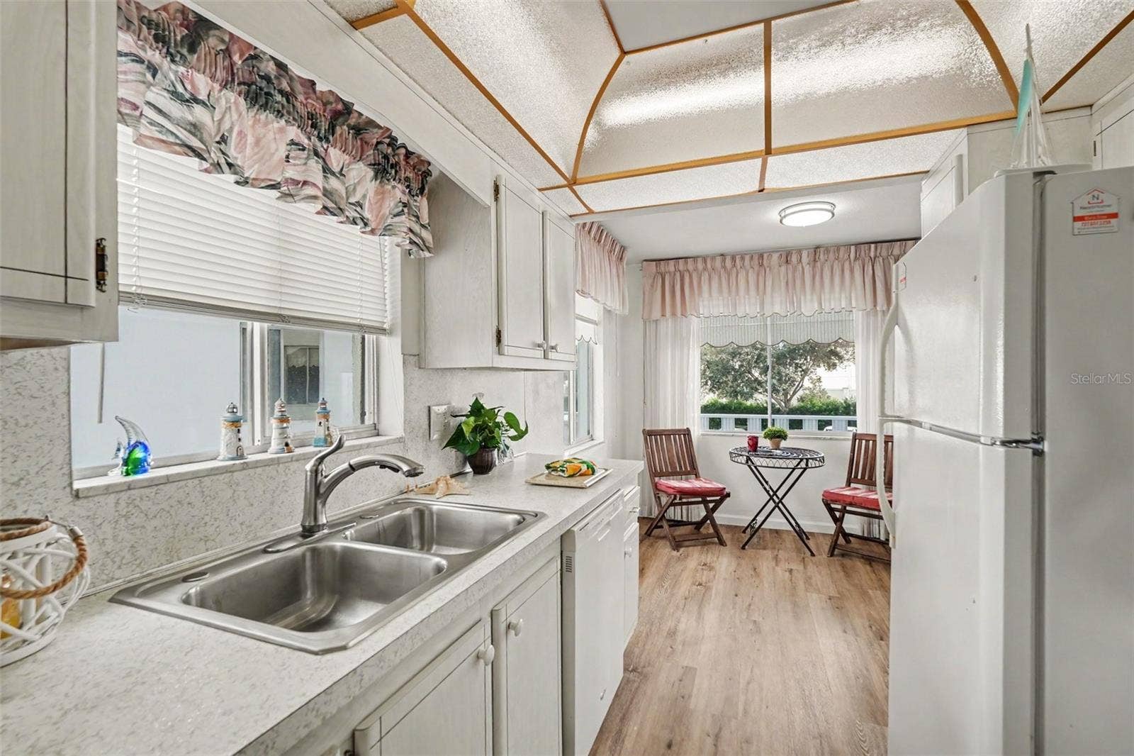 11201 80TH AVENUE, #209, Seminole, FL 33772 Super cute kitchen has lots of natural light and a view from the sink of the lovely pond with waterfall!