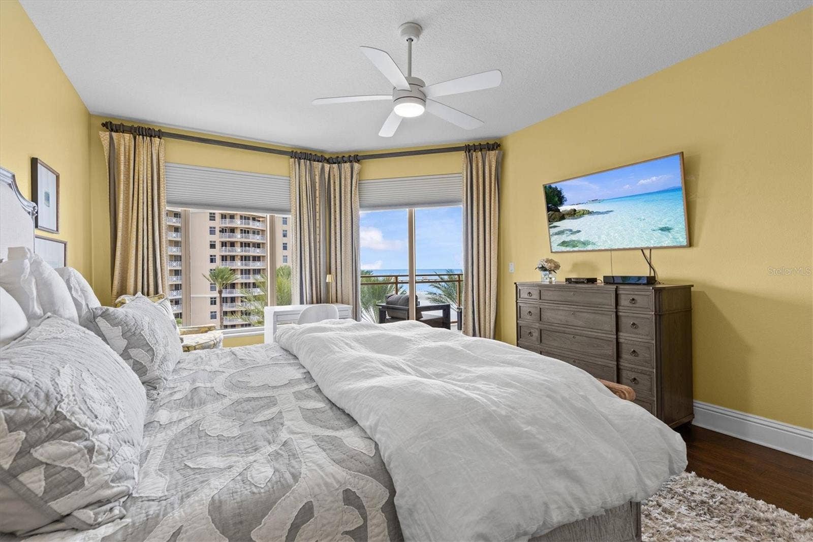 Peaceful primary suite with Gulf views and sliders opening to the private balcony.