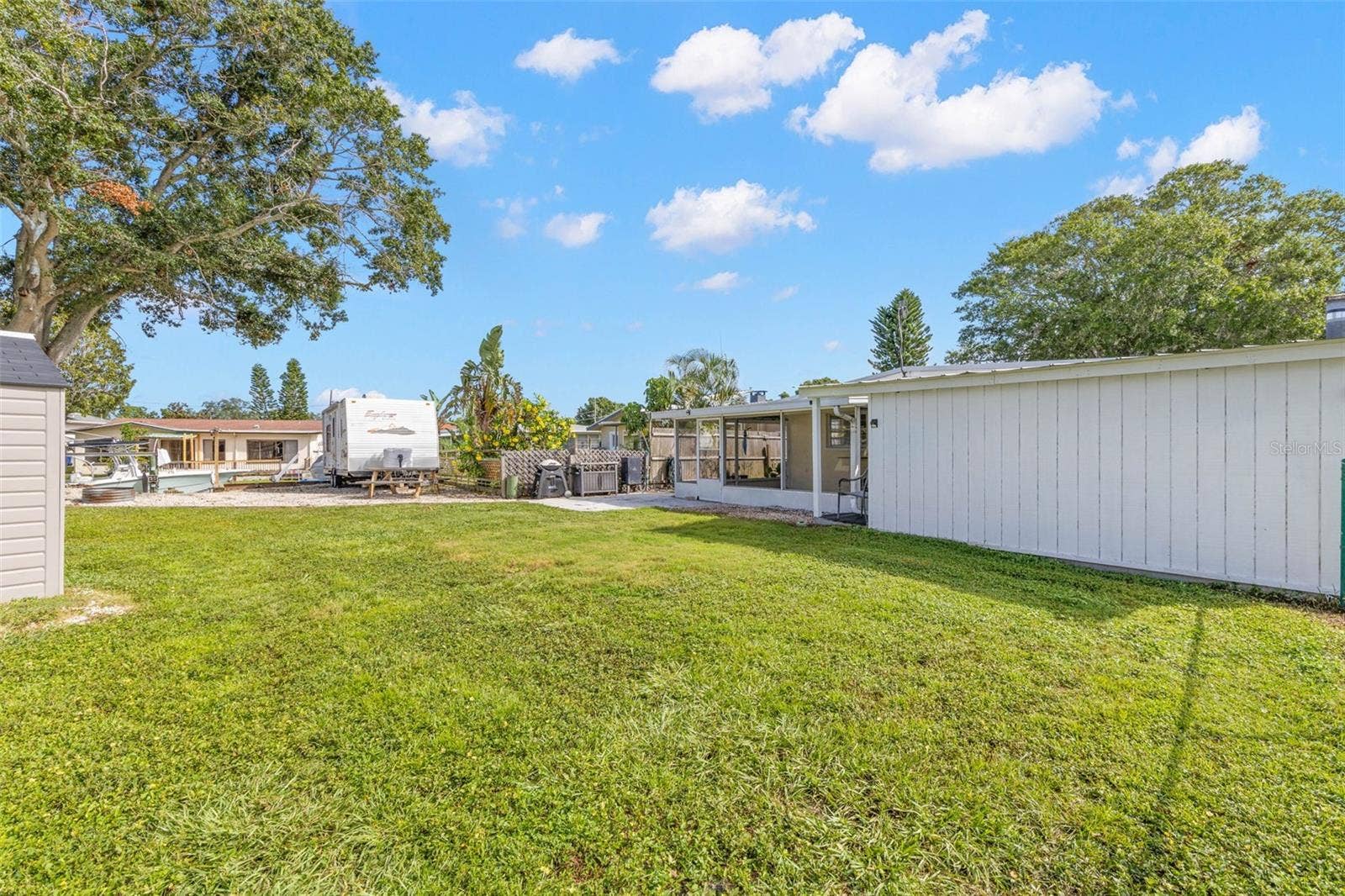The oversized 11,800-square-foot (.27-acre) property continues into a broad backyard with generous lawn space, fencing for added separation, and plenty of room for pets, play, gardening, or outdoor projects.