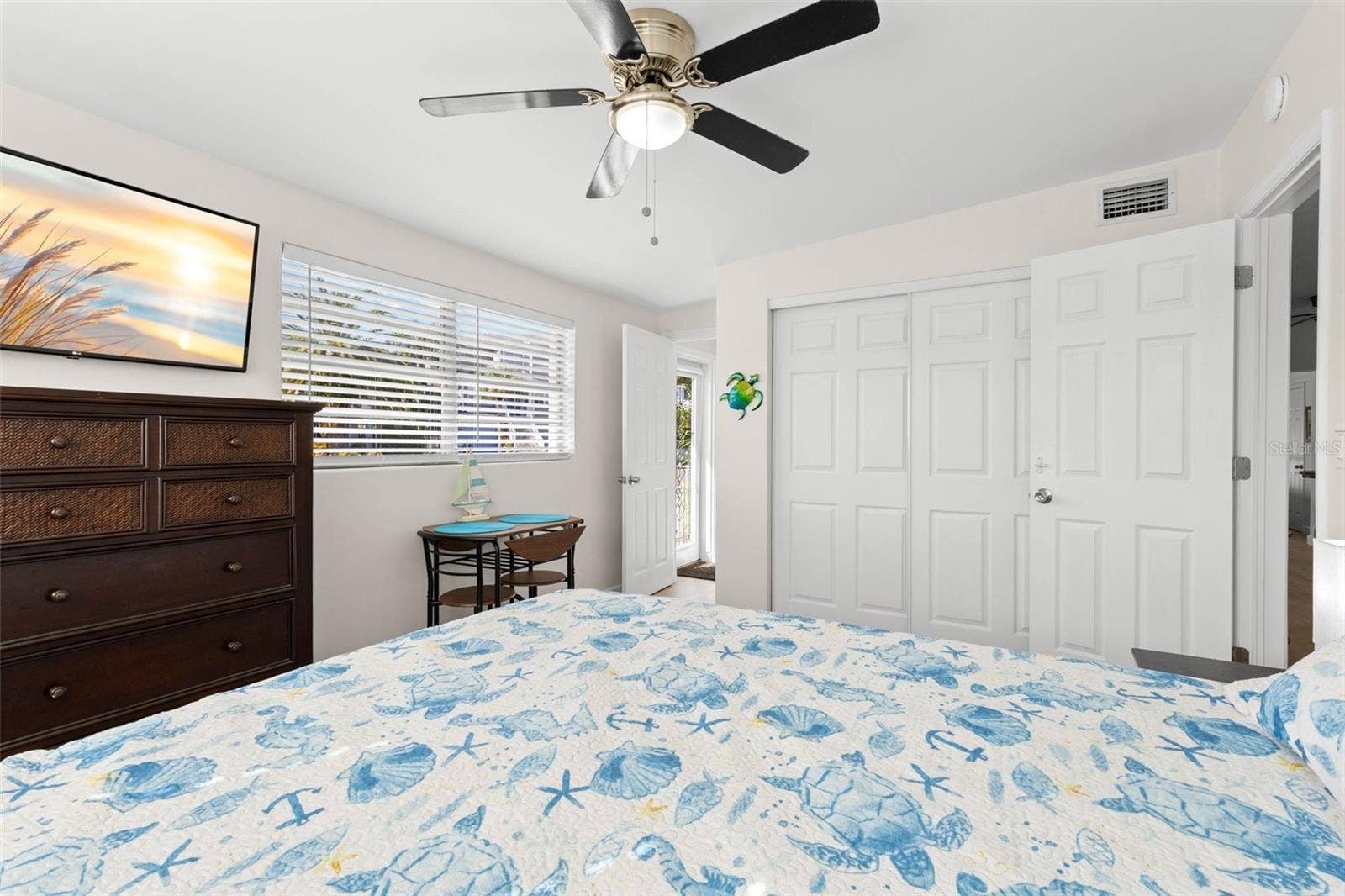 The third bedroom includes a wide closet, large window, ceiling fan, neutral finishes, and luxury vinyl plank flooring (2025), with plenty of room for additional furniture or a small sitting area.