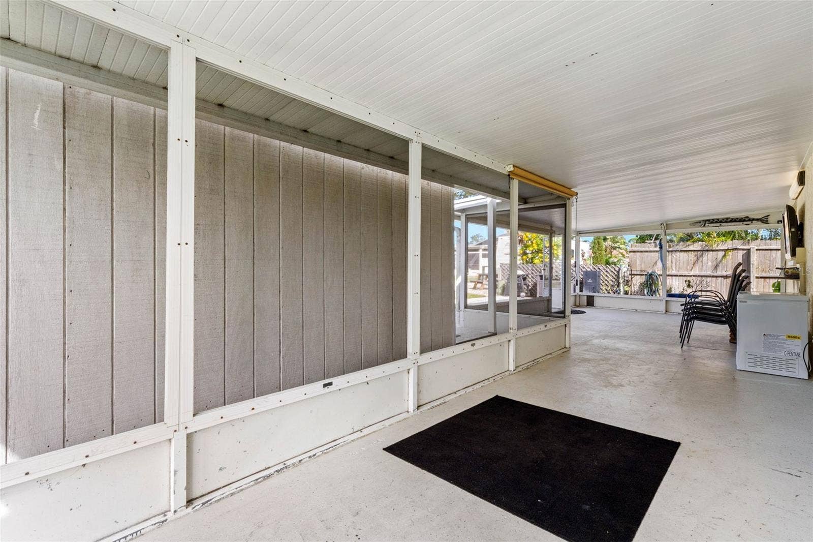 The spacious screened lanai offers a long stretch of covered outdoor living space with plenty of room for dining, lounging, and gathering while staying shaded from the Florida sun.
