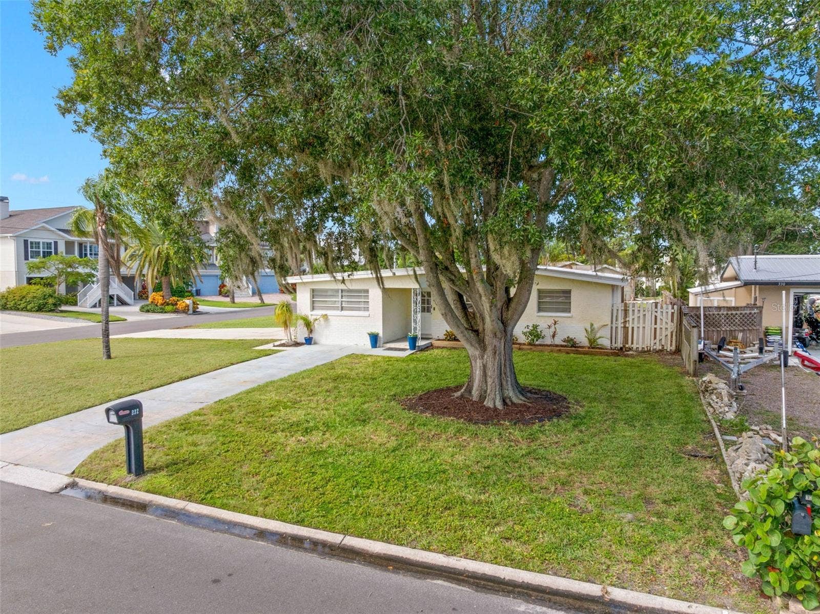 magnificent mature oak anchors the broad front lawn, while the homes corner setting creates a wonderful sense of space and separation from neighboring properties.