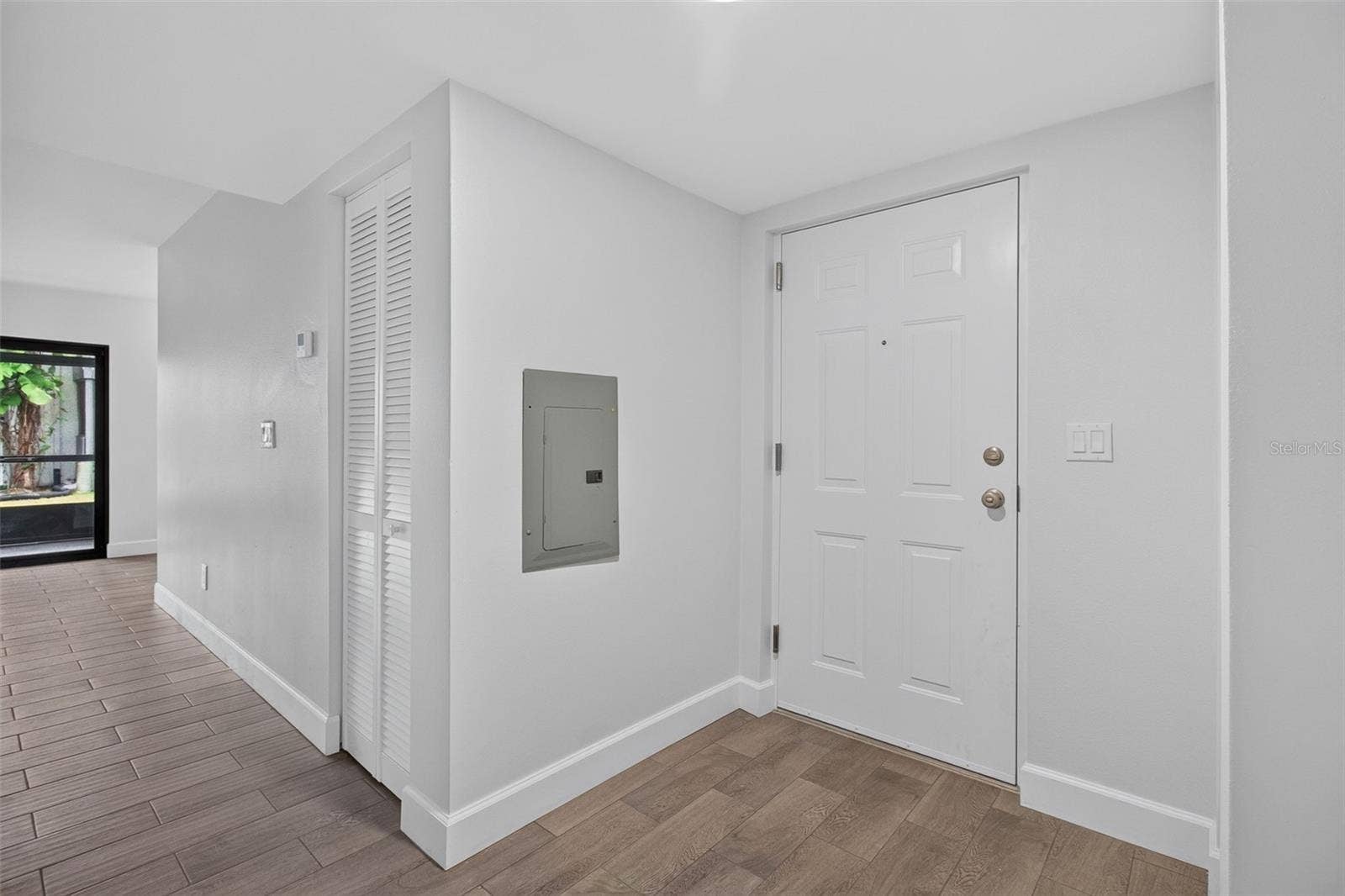 876 116TH AVENUE N, #103, St Petersburg, FL 33716 Foyer with new front door and newer electrical panel