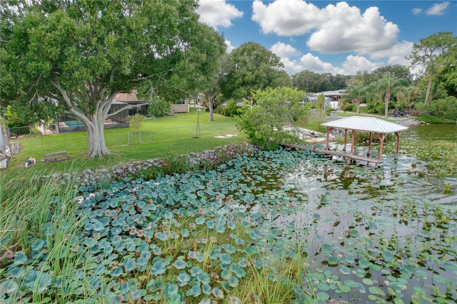 1348 EDGEWATER BEACH DRIVE, Lakeland, FL 33805 Aerial view from water of backyard, dock, and ramp