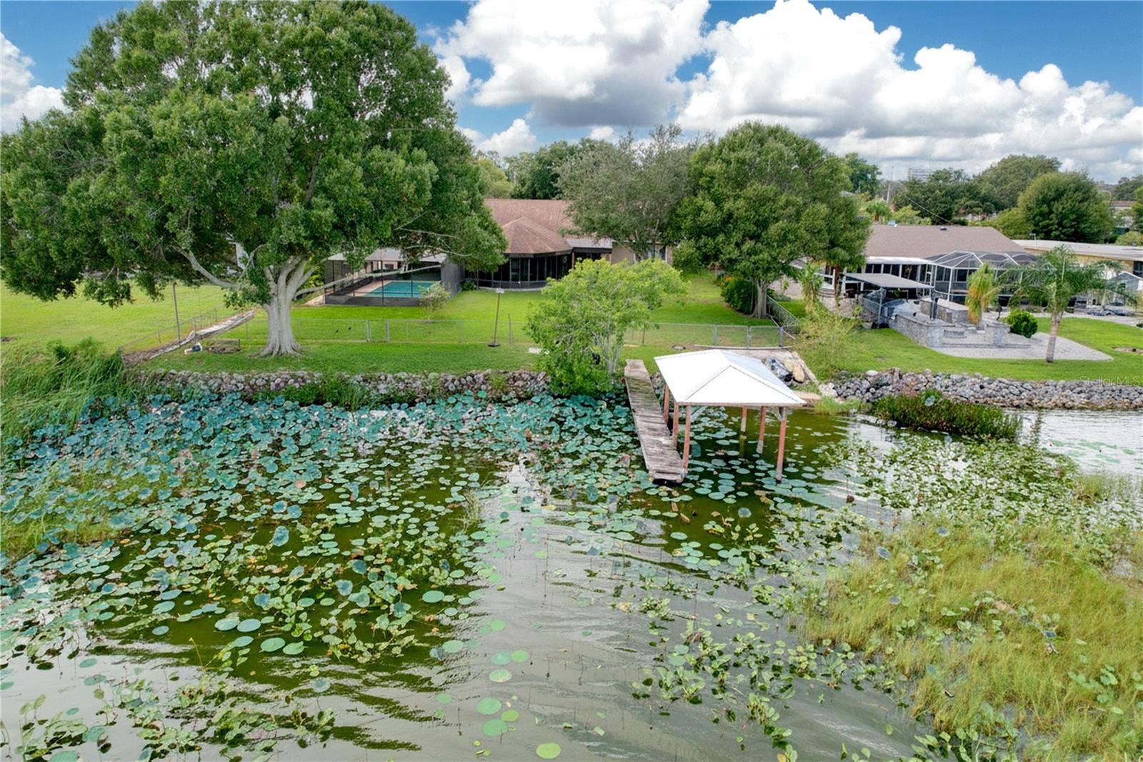 1348 EDGEWATER BEACH DRIVE, Lakeland, FL 33805 Aerial view from water of backyard, dock, and ramp