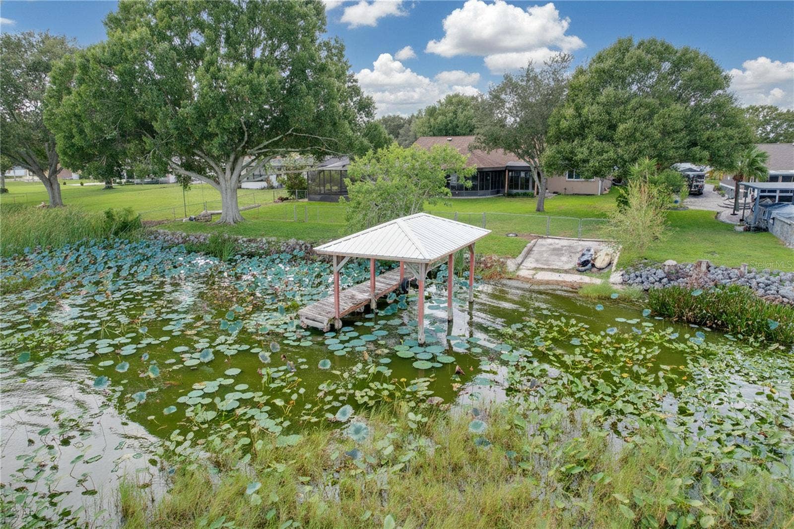 1348 EDGEWATER BEACH DRIVE, Lakeland, FL 33805 Aerial view from water of backyard, dock, and ramp