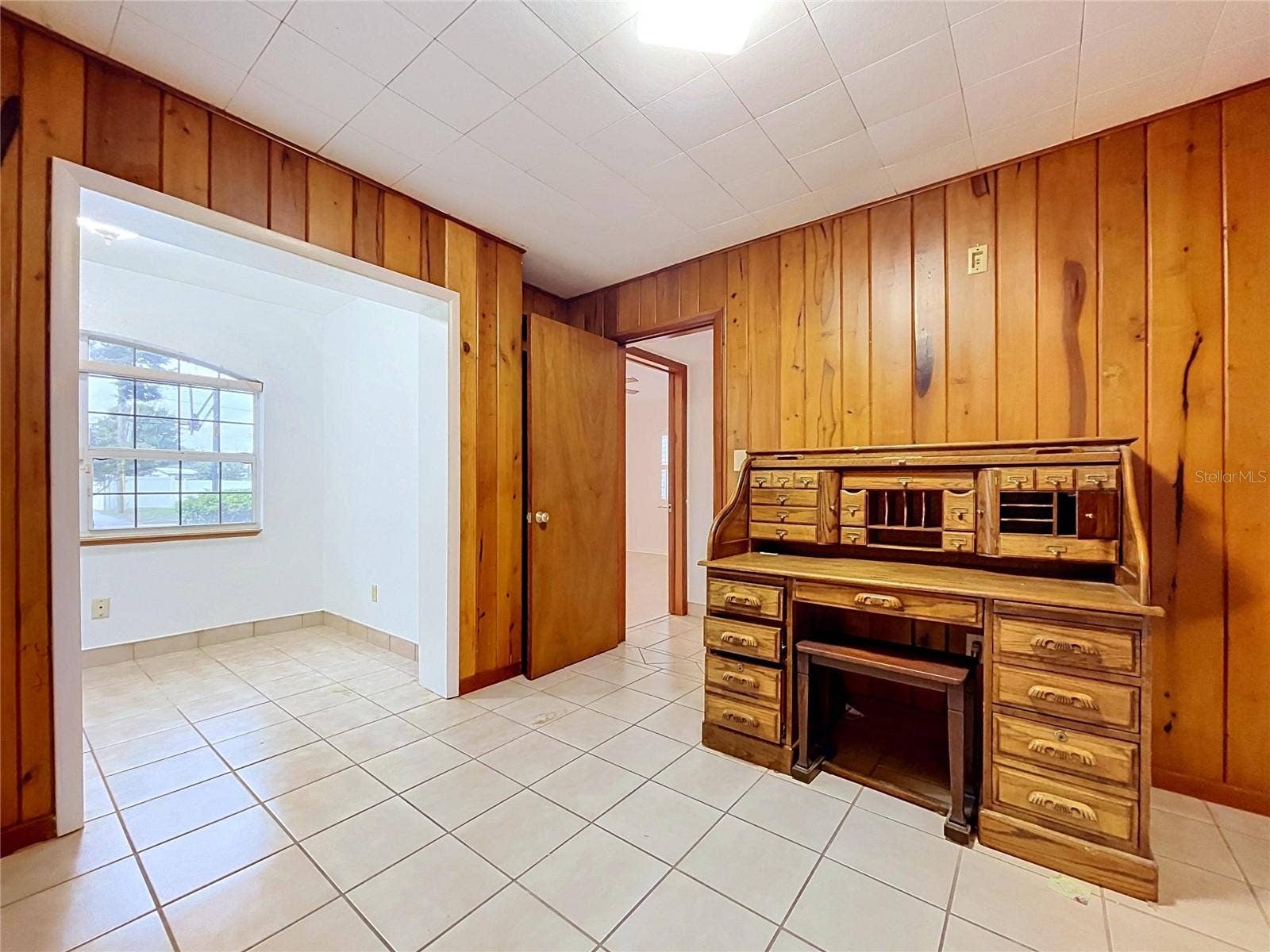 1348 EDGEWATER BEACH DRIVE, Lakeland, FL 33805 Bedroom 3 with wood-paneled walls (desk - personal property not included)