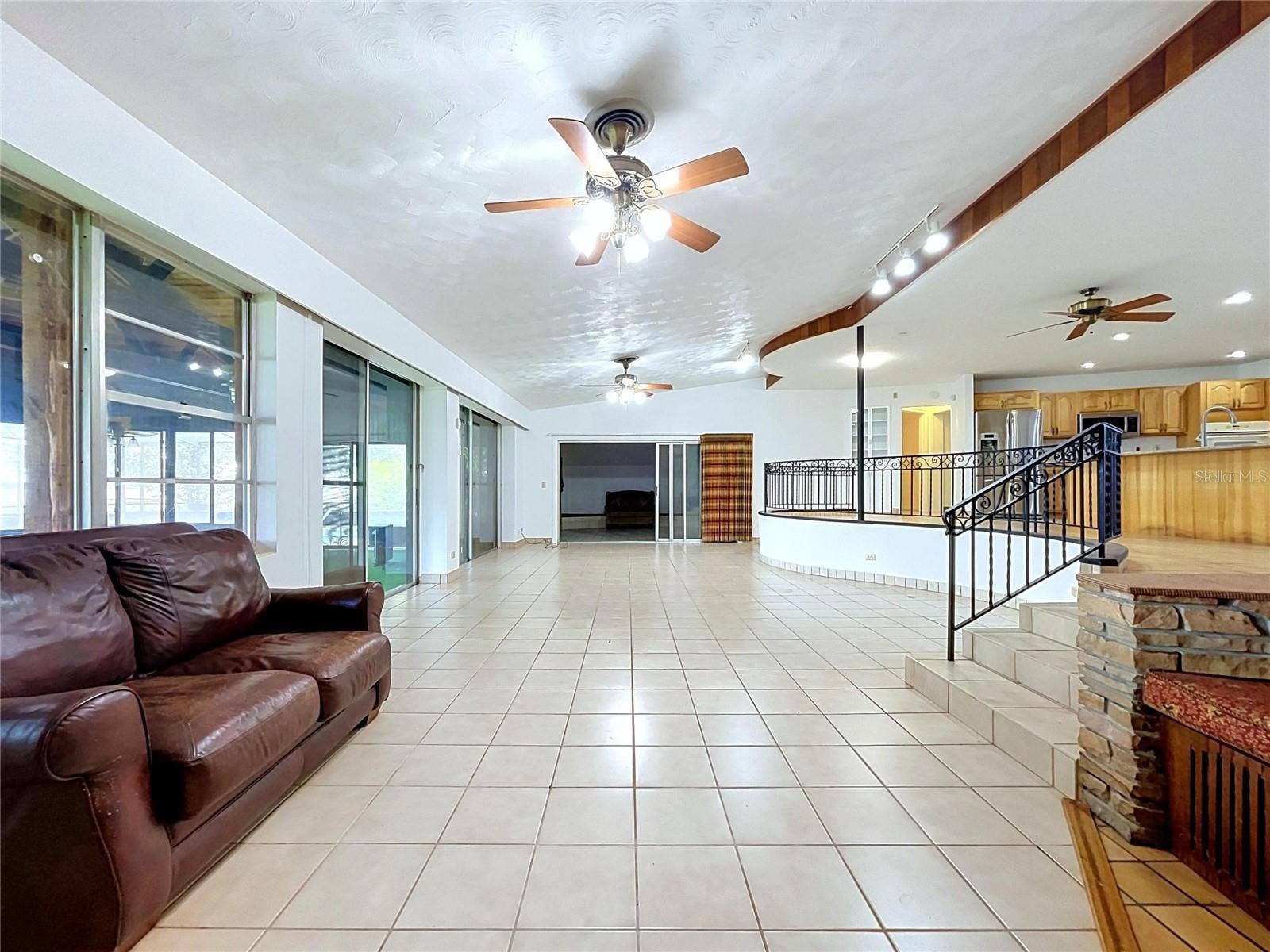 1348 EDGEWATER BEACH DRIVE, Lakeland, FL 33805 Living area with large windows / sliding glass doors
