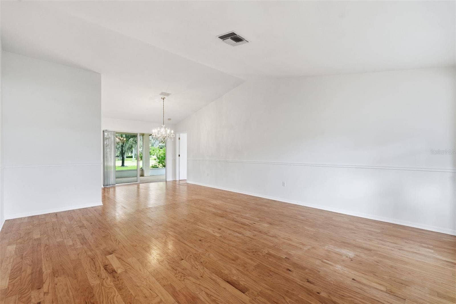 1444 CANBERLEY COURT, New Port Richey, FL 34655 From front door entrance - Spacious living room. Chandelier does NOT convey.
