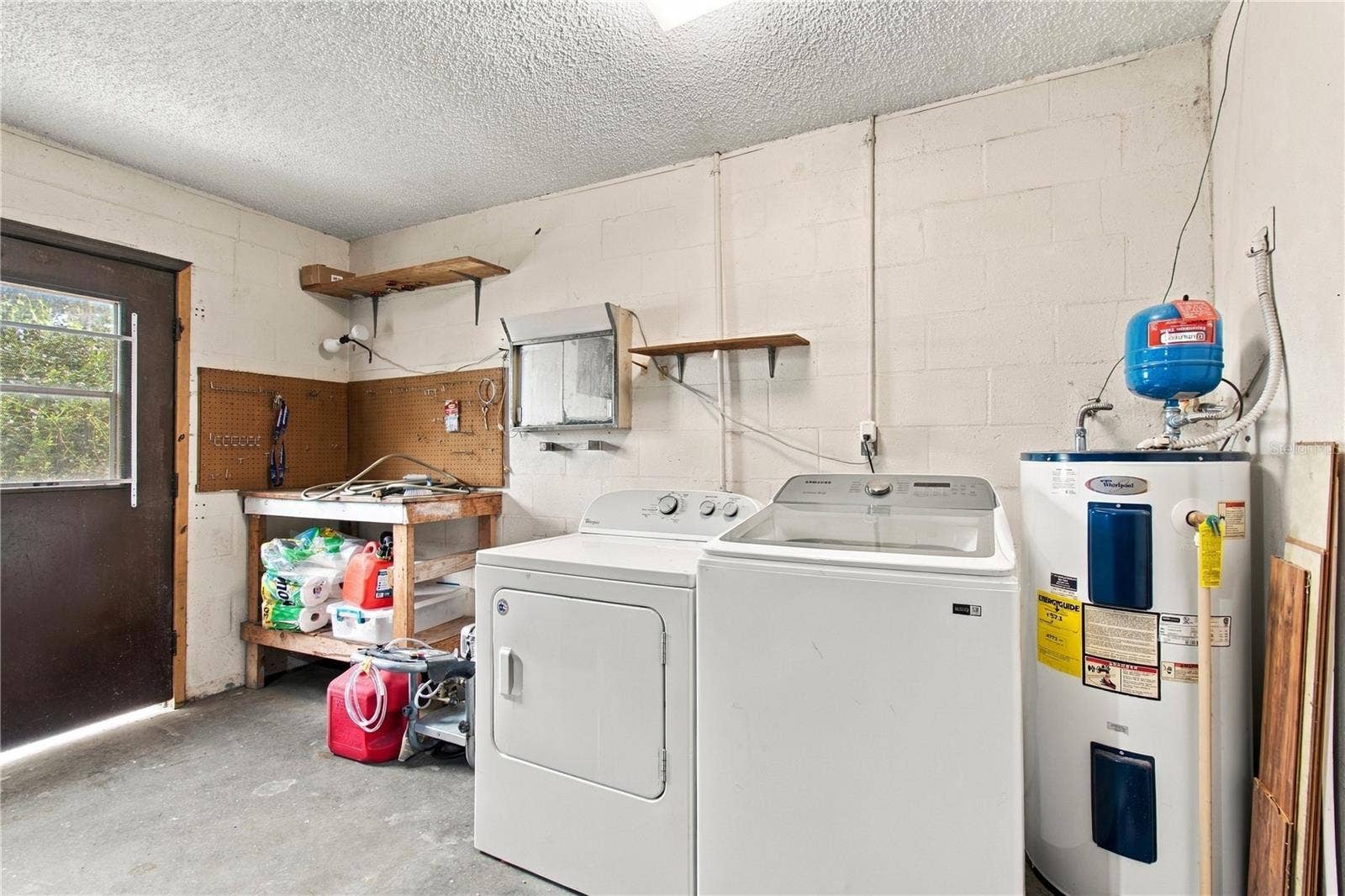 8410 ANGELA COURT, Zephyrhills, FL 33541 Washer, Dryer, and Water Heater are in the Garage