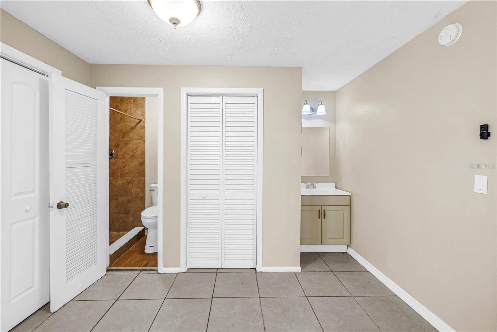 primary bedroom including bathroom and sink