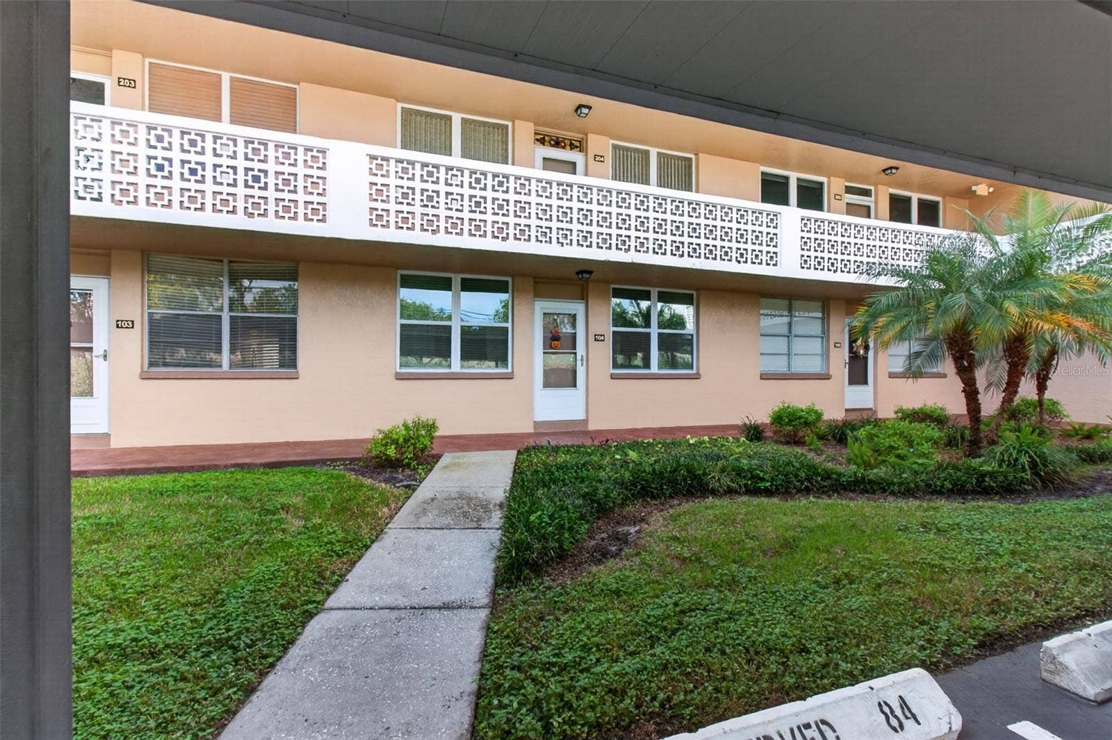 5095 BAY STREET NE, #104, St Petersburg, FL 33703 Front walkway from your covered deeded parking space #84 in front of the unit.