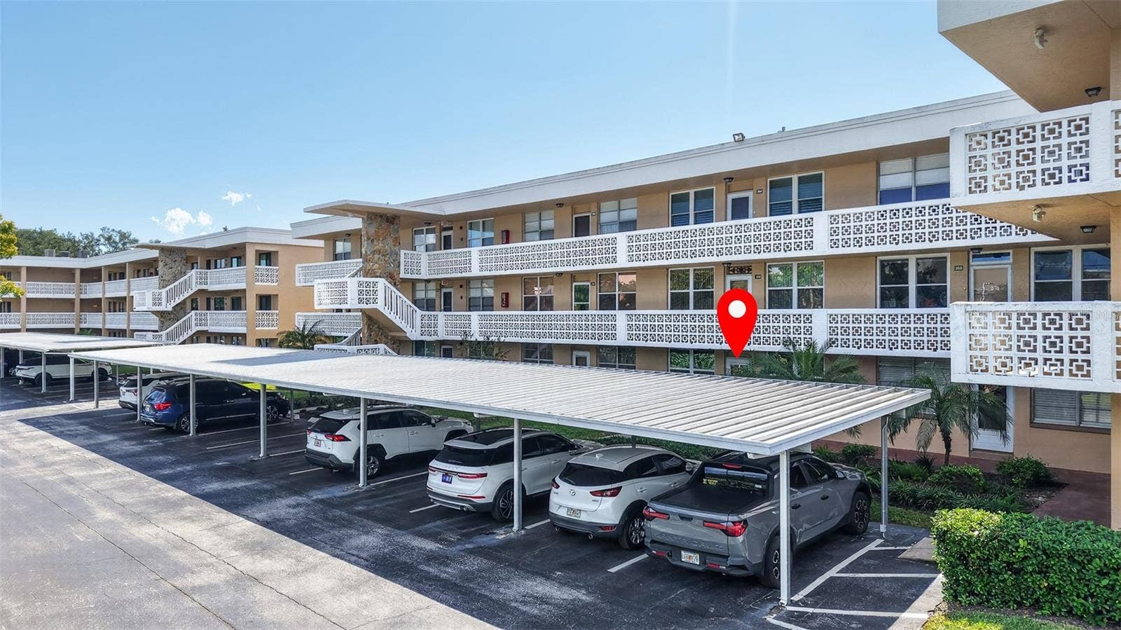 5095 BAY STREET NE, #104, St Petersburg, FL 33703 Front of building with covered parking.