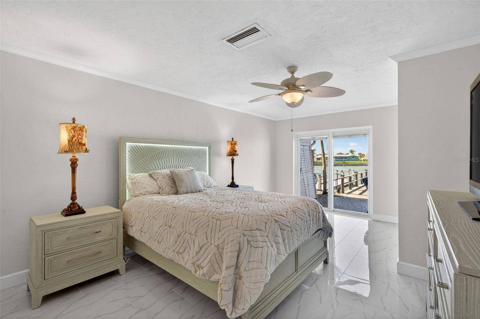 427 BOCA CIEGA POINT BOULEVARD N, St Petersburg, FL 33708 Primary Bedroom with access to the back porch, dock, and waterway.