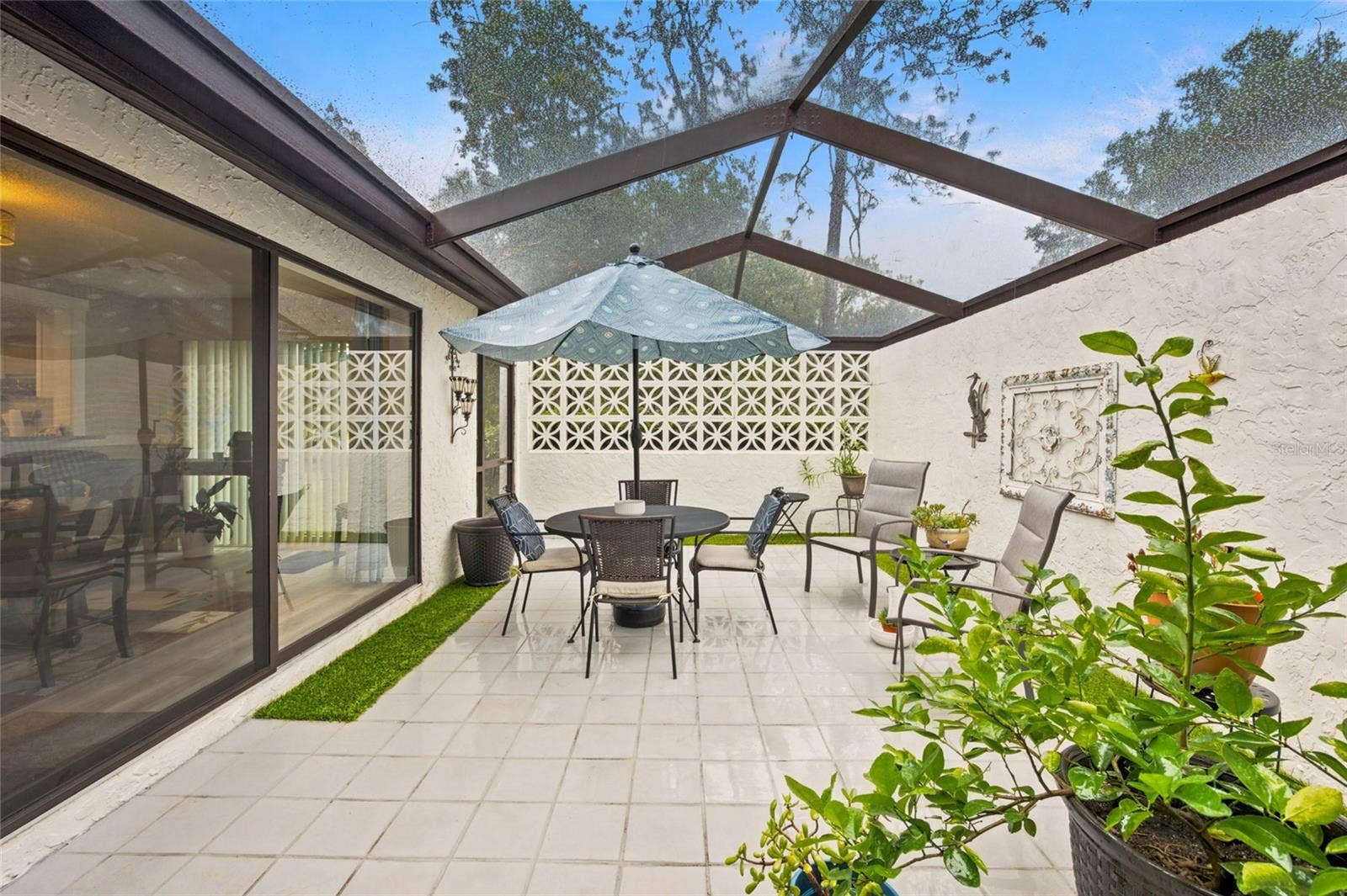 1 QUAIL RUN, Homosassa, FL 34446 Imagine Enjoying Some Wine or Coffee with Privacy - Architectural Decorative Breeze Blocks and Screen Door to Yard. Great Space to Be to Spend Time Safely with Your Fur Baby Outside in The Fresh Air - View from Primary & Kitchen