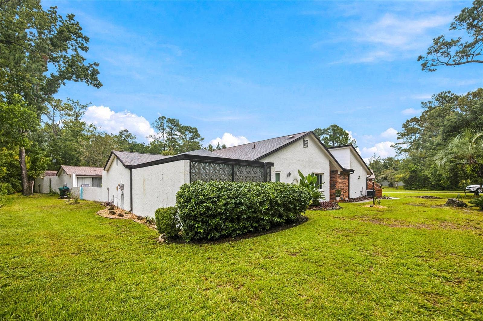 1 QUAIL RUN, Homosassa, FL 34446 Rear View with Private Courtyard Designed Pretty Architectural Breeze Blocks