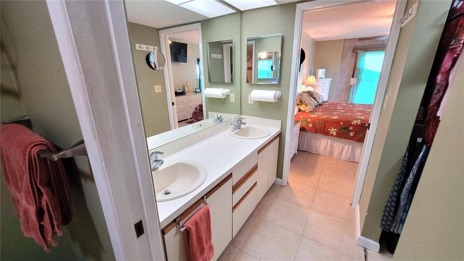1806 MARINER DRIVE, #318, Tarpon Springs, FL 34689 There is a pocket door on each side of the double sinks for privacy.
