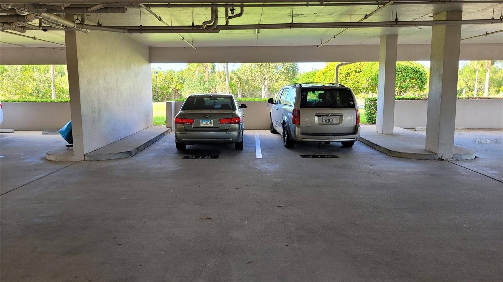 1806 MARINER DRIVE, #318, Tarpon Springs, FL 34689 On your way in or out of 1806, you will find your under building assigned parking space. Great for Florida's deluge rains!
