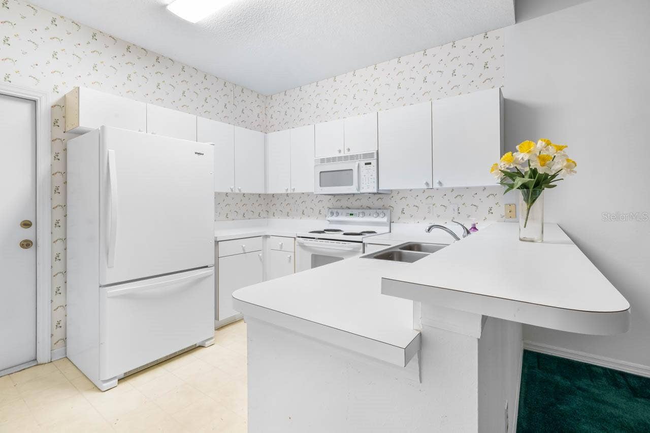2617 NEWCOMB COURT, Sun City Center, FL 33573 Kitchen with door leading to the garage