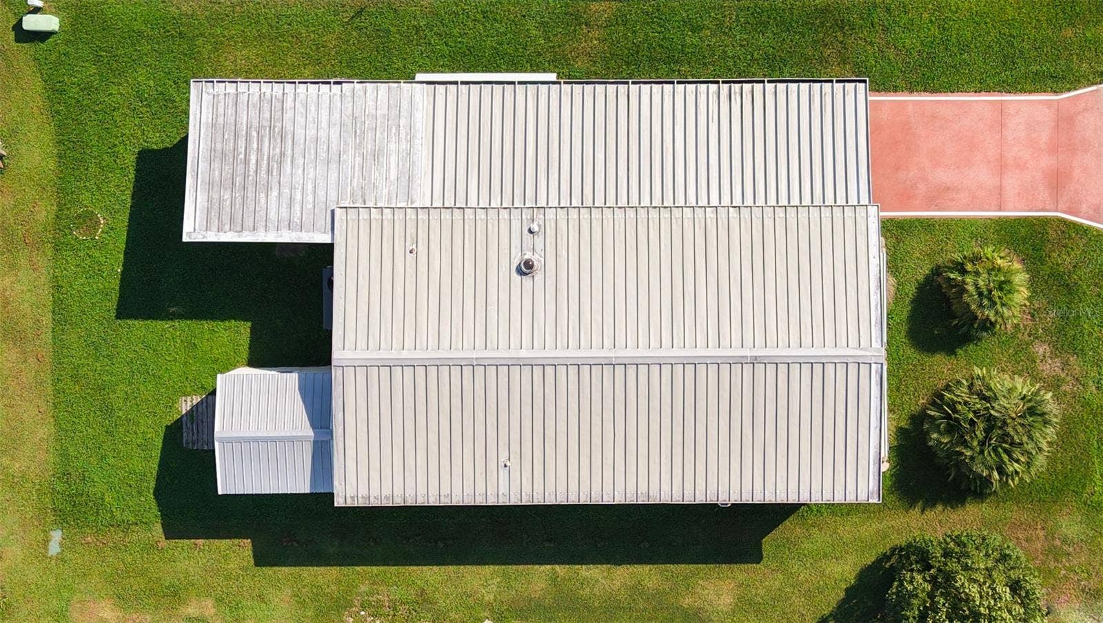 5716 PAWNEE STREET, Zephyrhills, FL 33542 metal roof over.