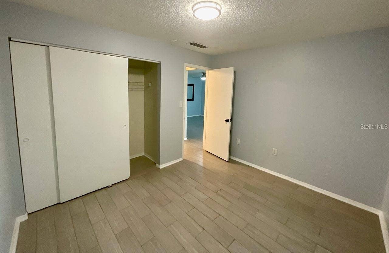 Bedroom 1 with large closet and door to hallway