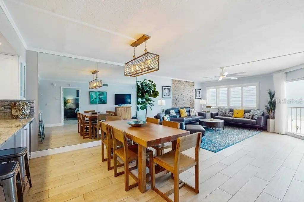 18400 GULF BOULEVARD, #1208, Indian Shores, FL 33785 AMPLE GREAT ROOM AREA WITH STUNNING BEACH VIEWS, NATURAL STONE WOOD-BURNING FIREPLACE, AND OPEN KITCHEN COUNTER WITH ADDITIONAL WINE FRIDGE.