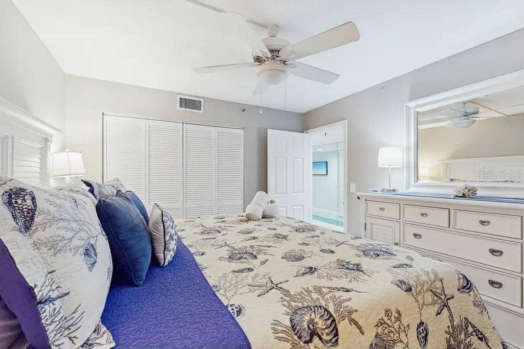 18400 GULF BOULEVARD, #1208, Indian Shores, FL 33785 SPLIT FLOOR PLAN FEATURES SECOND BEDROOM OFFERS KING SIZE BED, CEILING FAN, AND FLAT TV.