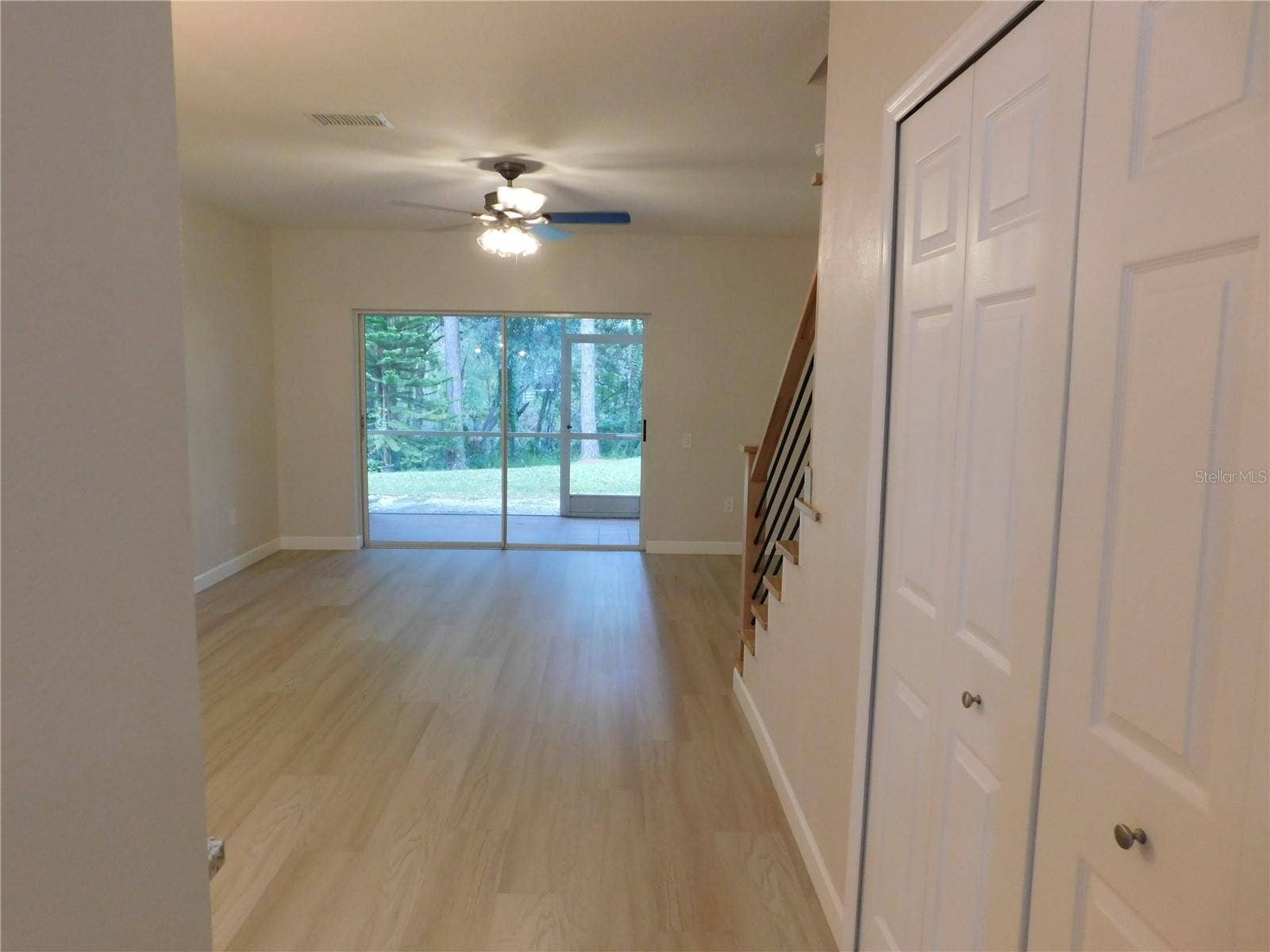 8660 HUNTERS KEY CIRCLE, Tampa, FL 33647 Living Area features new modern LVP and new Wood stairs for a modern finish