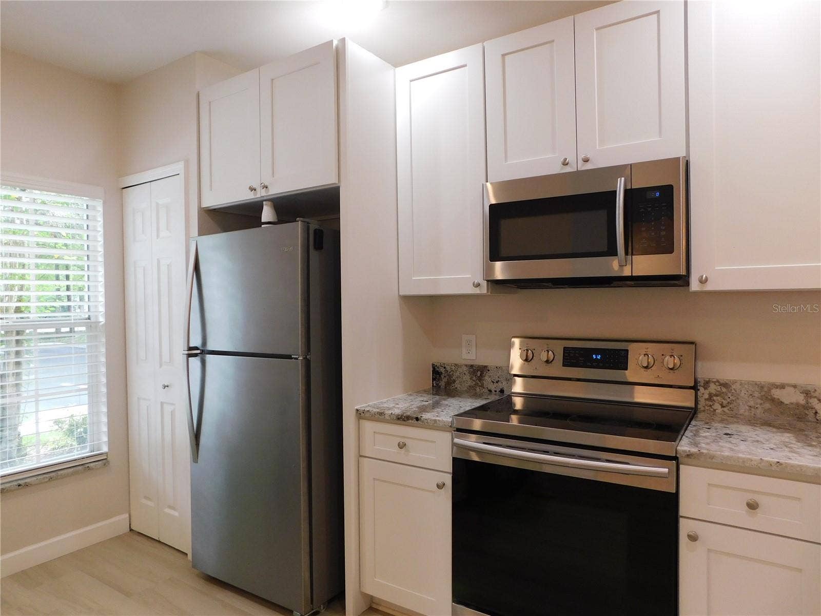 8660 HUNTERS KEY CIRCLE, Tampa, FL 33647 Remodeled Kitchen with new cabinets, gorgeous Granite counters and large ss deep sink.