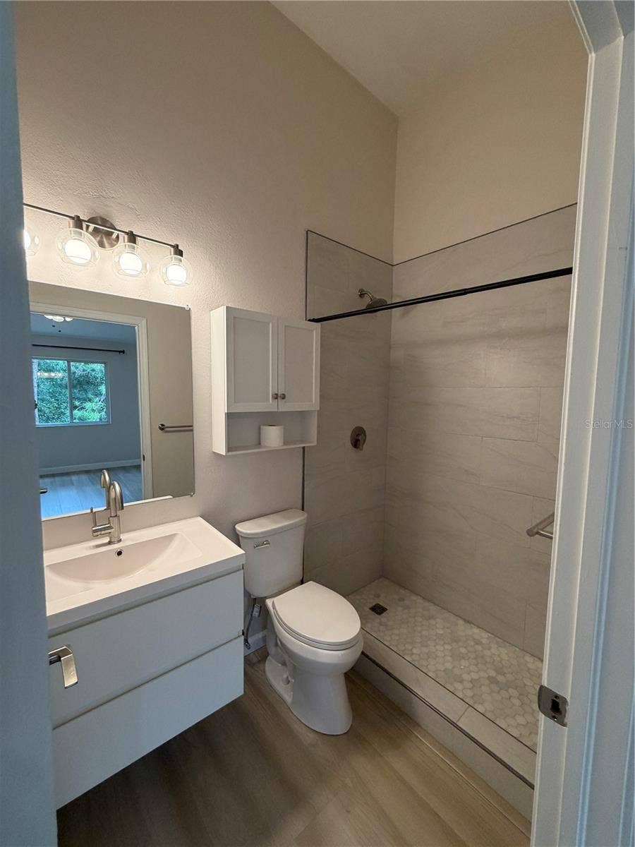 8660 HUNTERS KEY CIRCLE, Tampa, FL 33647 Primary 1 New Remodel Ensuite - Flooring, Shower tiles, Vanity and Faucet, Mirror, Toilet and Light Fixture.