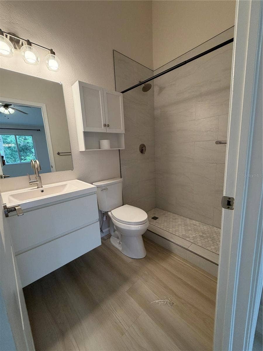 8660 HUNTERS KEY CIRCLE, Tampa, FL 33647 Primary 1 New Remodel Ensuite - Flooring, Shower tiles, Vanity and Faucet, Mirror, Toilet and Light Fixture.