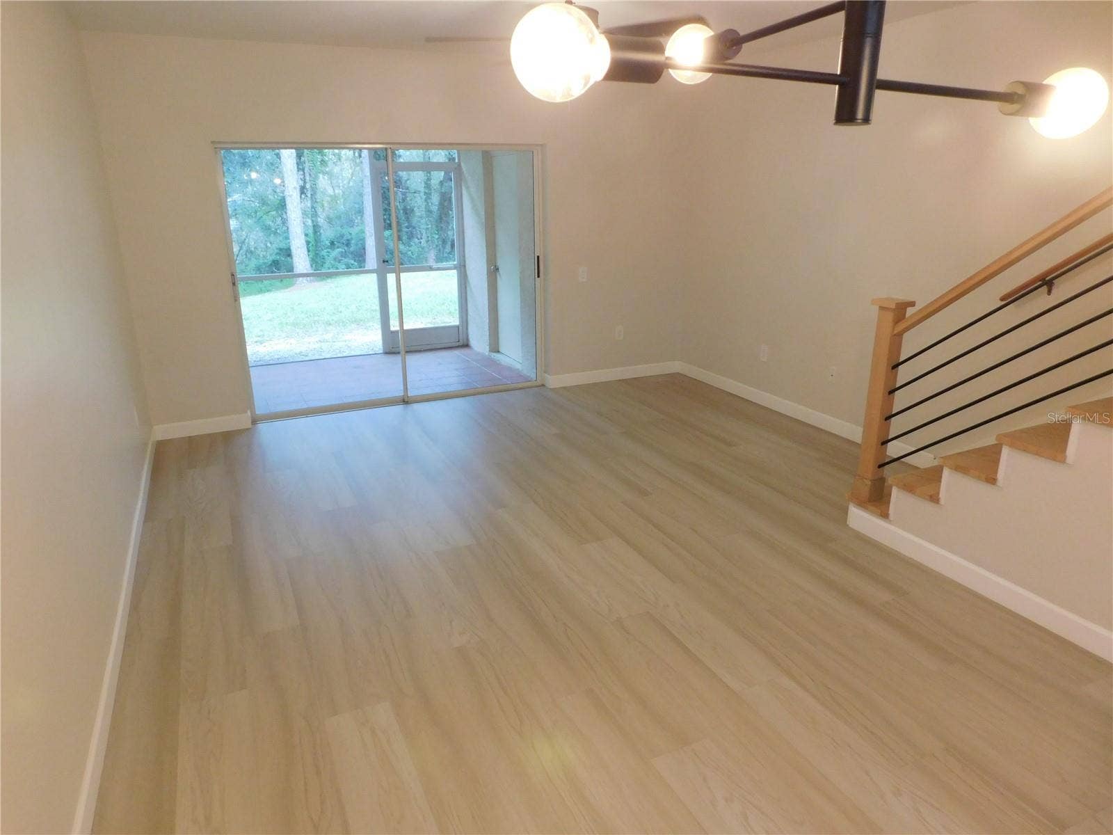 8660 HUNTERS KEY CIRCLE, Tampa, FL 33647 Living Area features new modern LVP and new Wood stairs for a modern finish