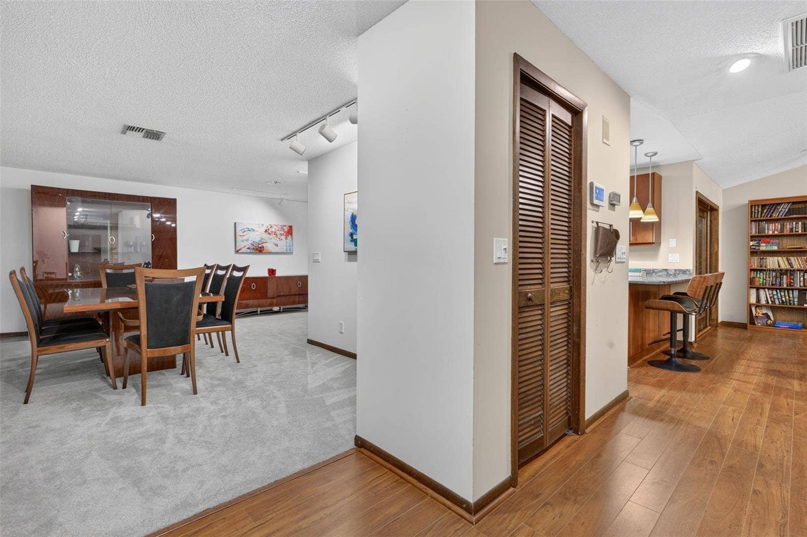 Foyer looking into dining room and coat closet