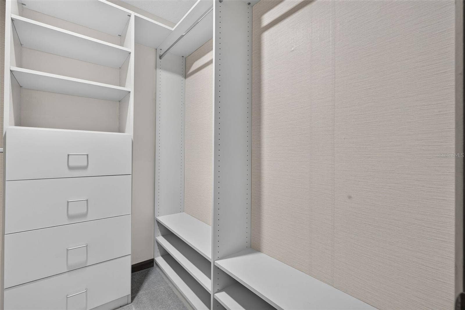 Primary bedroom walk in closet system