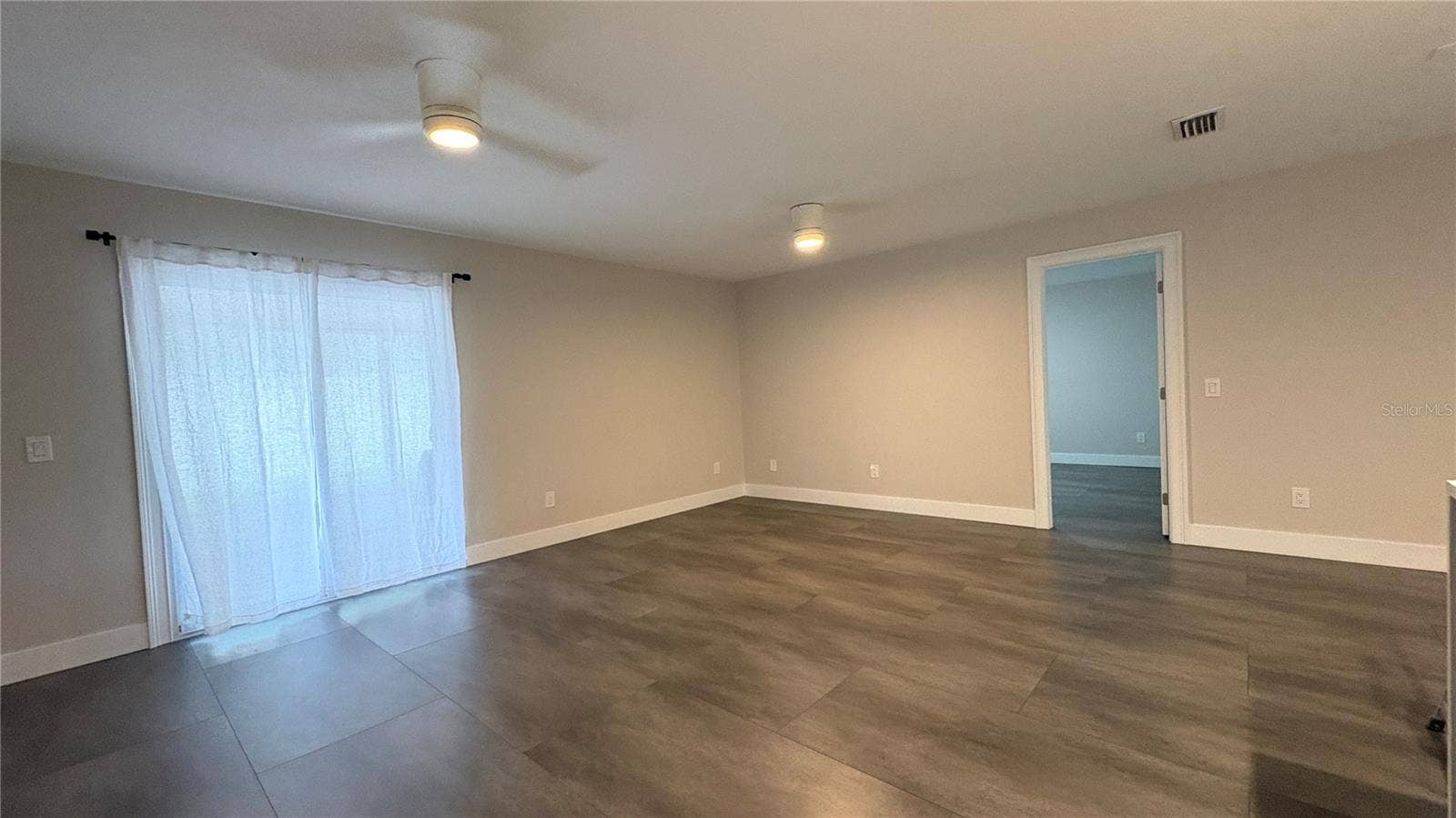 Living/Dining room with slider leading to screened in lanai.