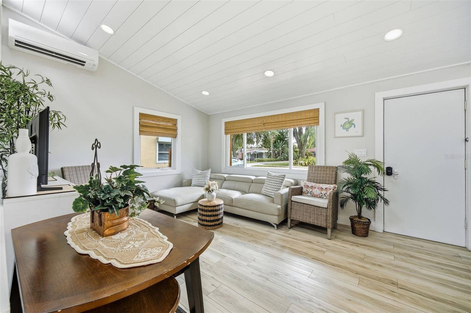Impact-resistant windows complemented by warm woven wood shades