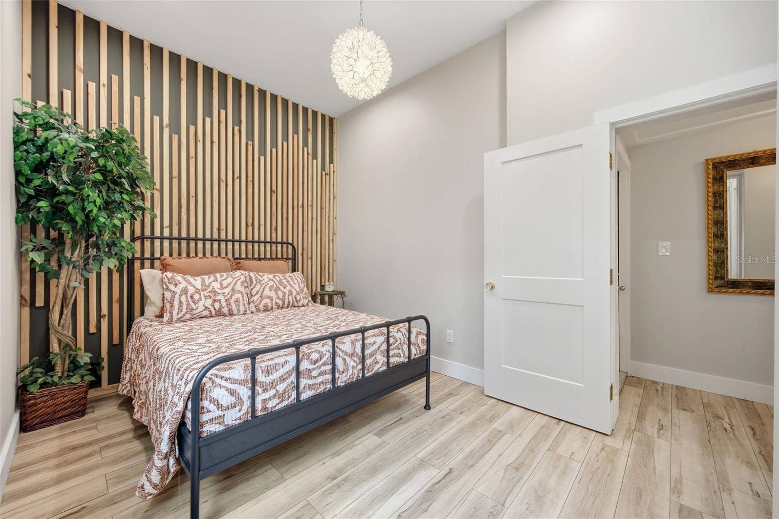 Dramatic wood-slat accent wall and statement lighting