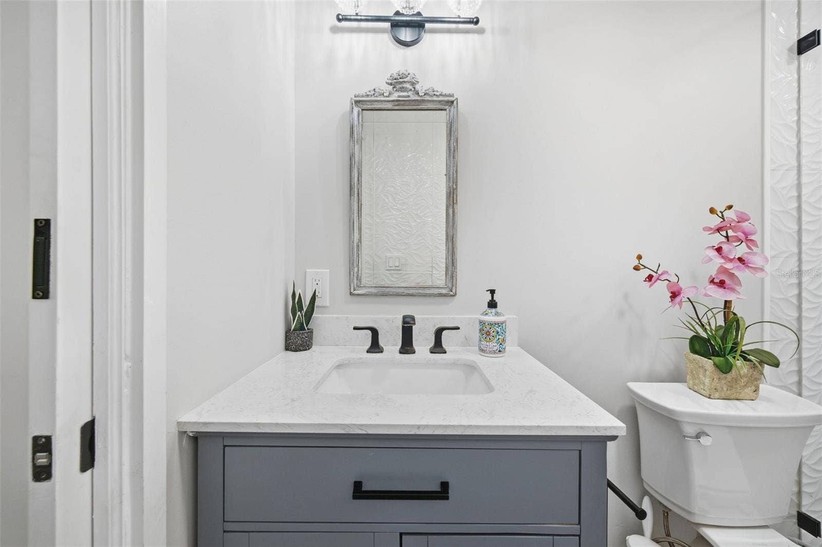 Quartz vanity and striking matte-black accents.