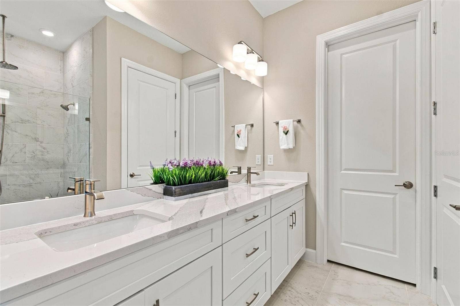 29749 CASSINO COURT, Wesley Chapel, FL 33543 Primary Bathroom with double vanity, huge walk-in shower with 3 different shower head options, private water closet and spacious closet