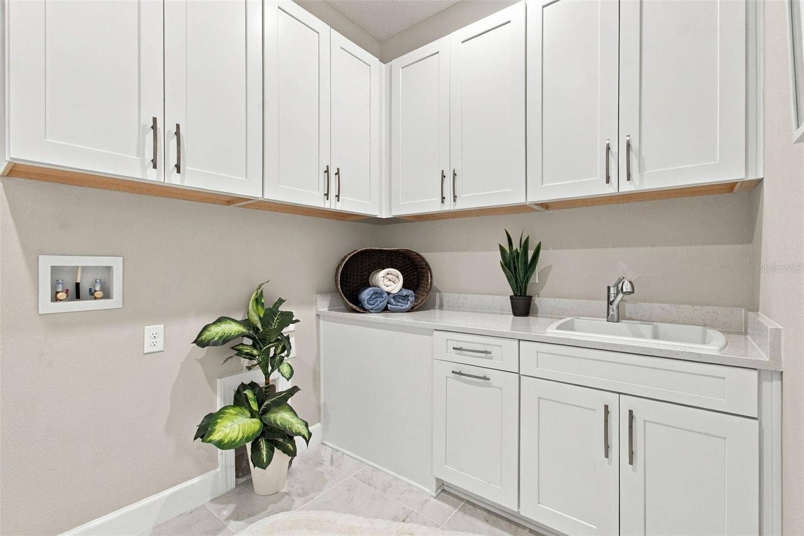 29749 CASSINO COURT, Wesley Chapel, FL 33543 Very large laundry room with upper and lower cabinets and a utility sink