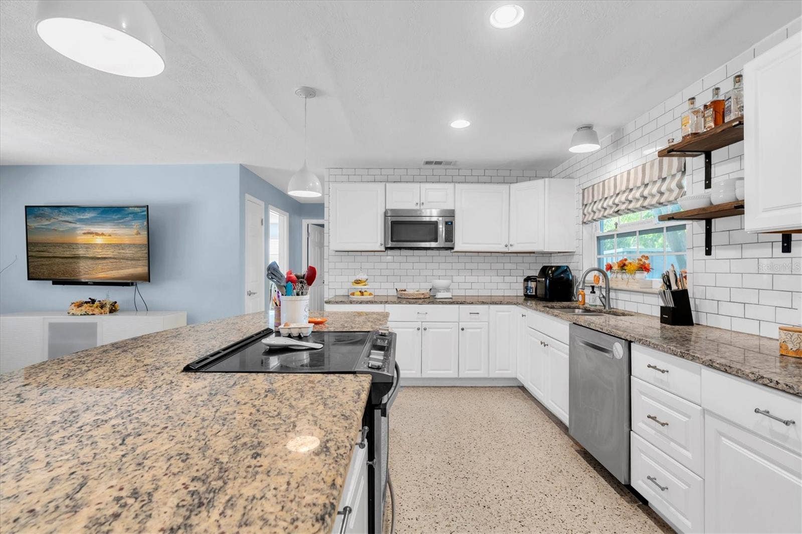 5701 6TH WAY S, St Petersburg, FL 33705 Updated kitchen with shaker-style cabinetry and granite counters