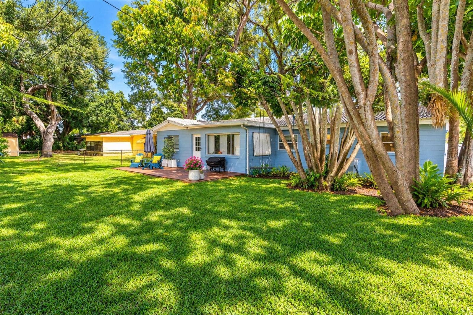 5701 6TH WAY S, St Petersburg, FL 33705 A magnificent, mature bottlebrush tree adds vibrant red blooms to the landscape.