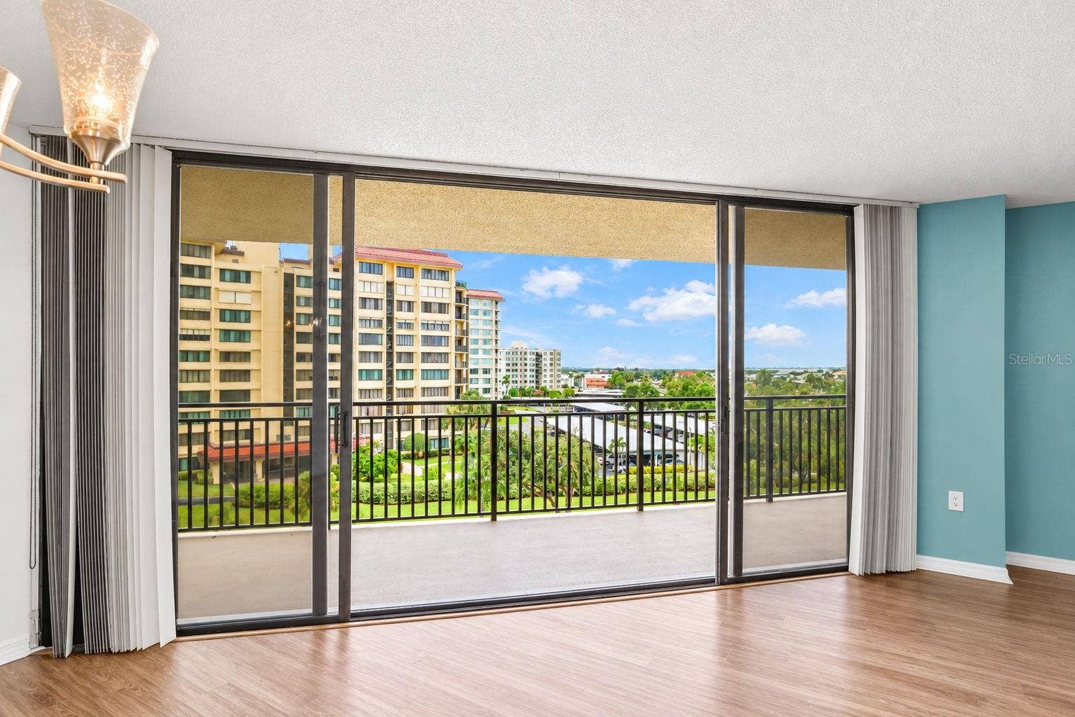 690 ISLAND WAY, #606, Clearwater, FL 33767 Large sliding doors from living/dining room. with easy close hurricane shutters