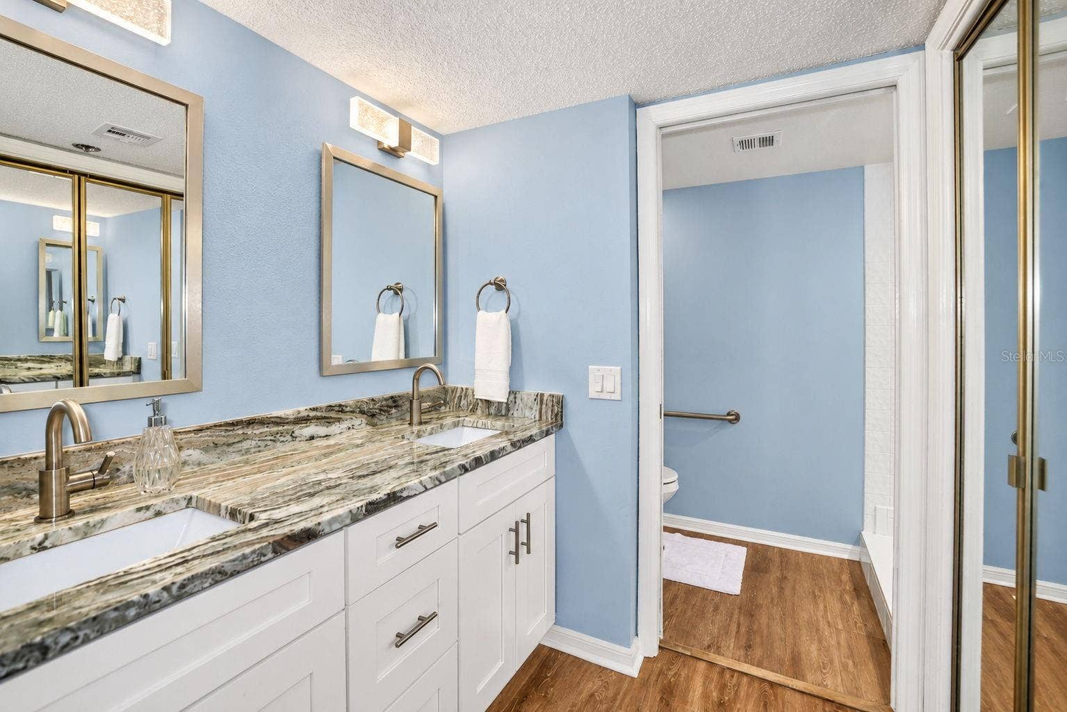 690 ISLAND WAY, #606, Clearwater, FL 33767 Primary Bathroom, newly updated with double sink shaker cabinet vanity with soft close drawers, lighting, mirrors and paint.