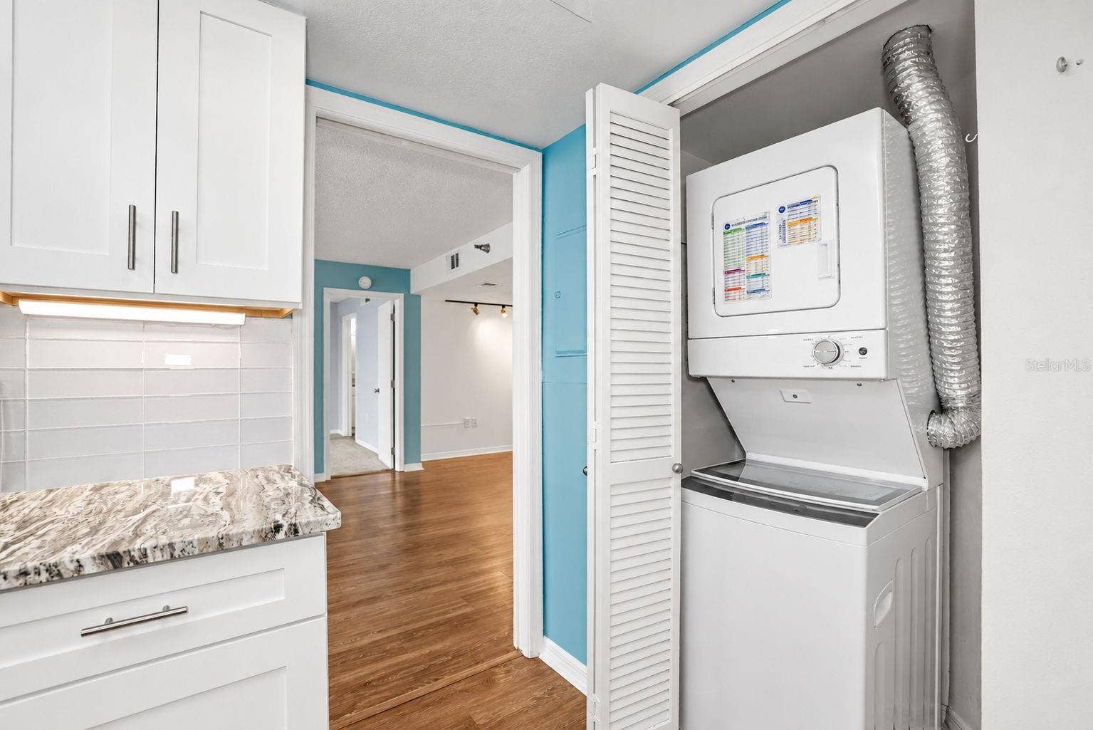 690 ISLAND WAY, #606, Clearwater, FL 33767 Notice pretty glass subway tiles and Washer Dryer conveniently located in the unit