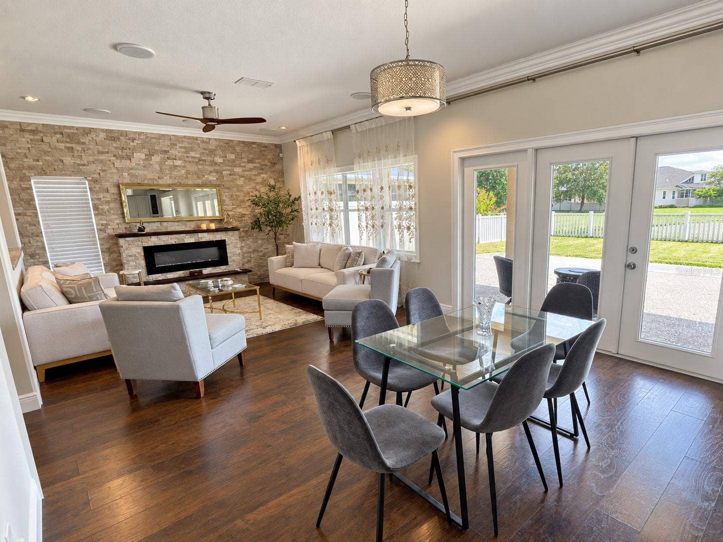 A bright, casual dining space connects the kitchen and family room, with glass patio doors providing outdoor access and views of the backyard.