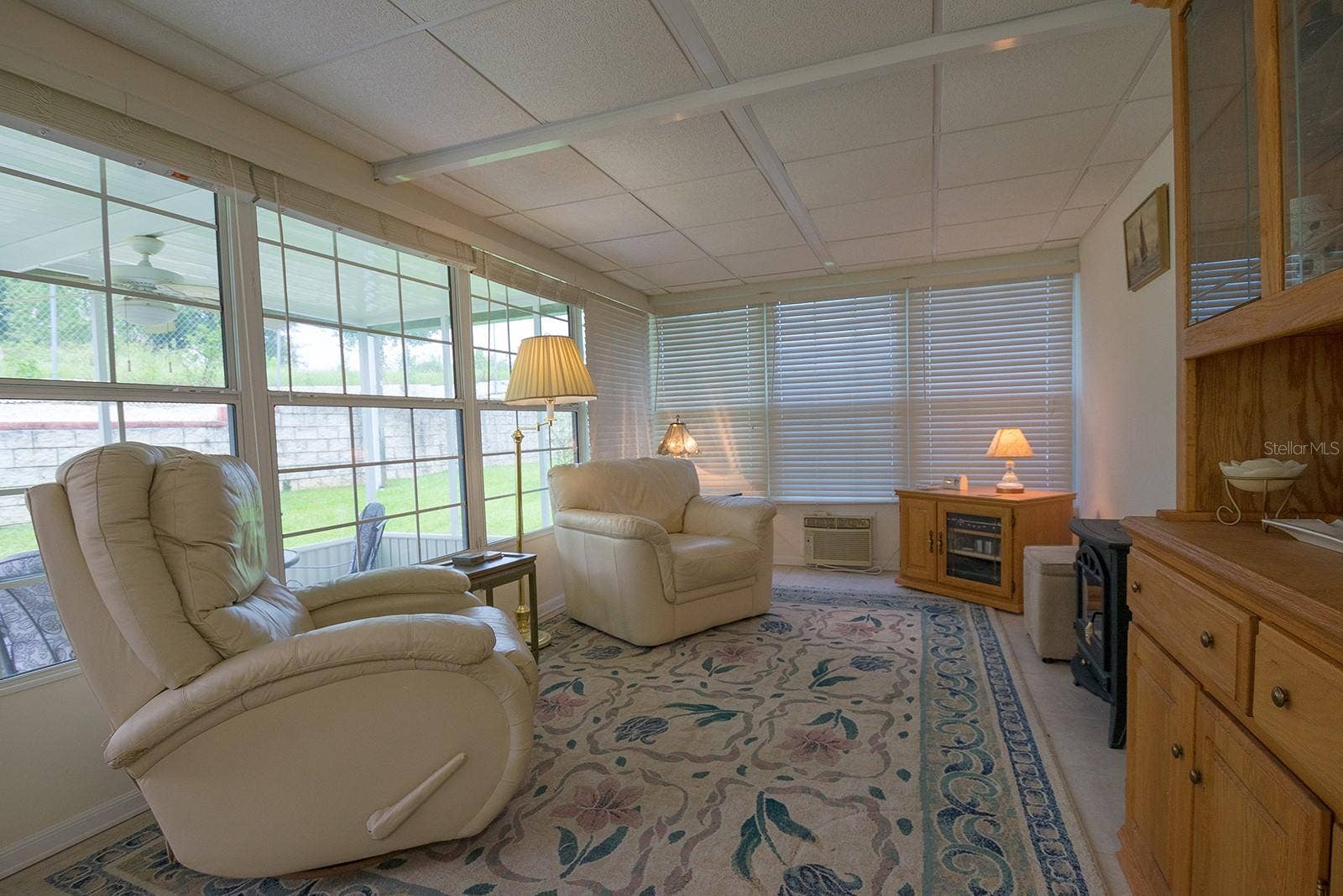 Enclosed Bonus/Florida room with ceramic tile floors, double pane windows and wall AC!