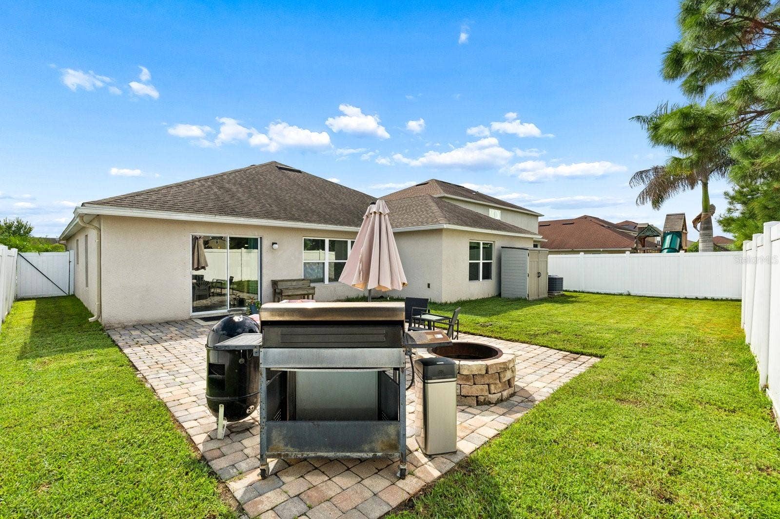 Pavered patio area with built in fire pit