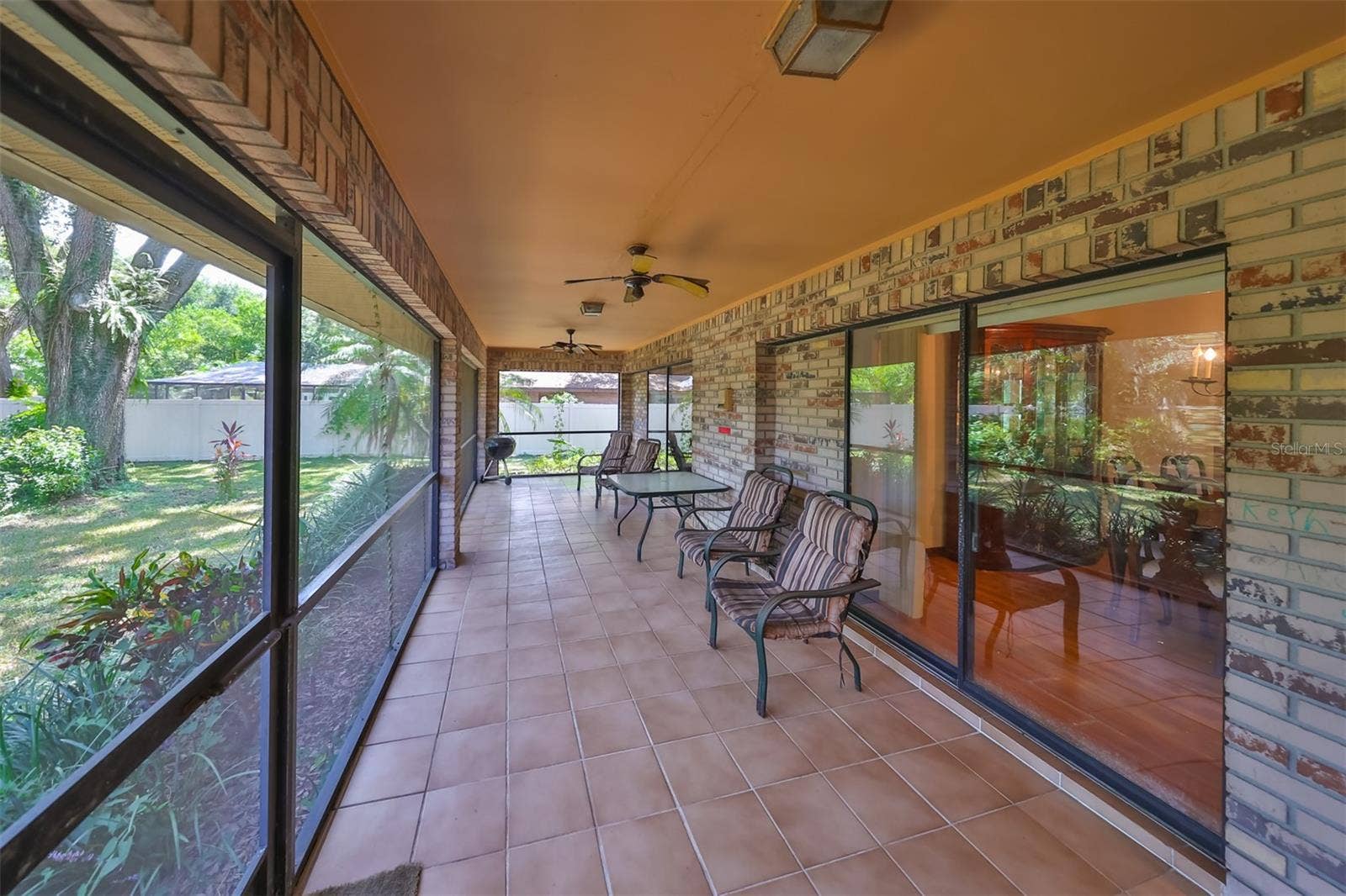 2609 MANOR OAK DRIVE, Valrico, FL 33596 Patio is HUGE with ceiling fans and a view of the vast backyard.