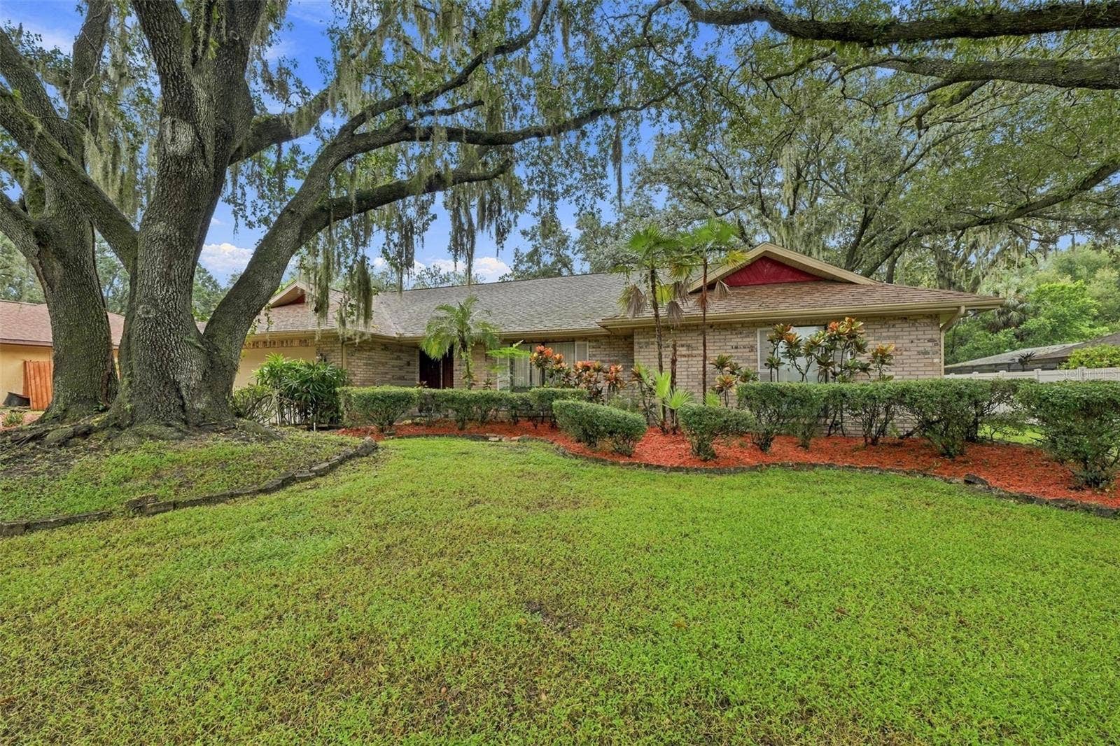 2609 MANOR OAK DRIVE, Valrico, FL 33596 This house sits on over third of an acre. Landscaping is simple and easy to care for in this huge front yard.